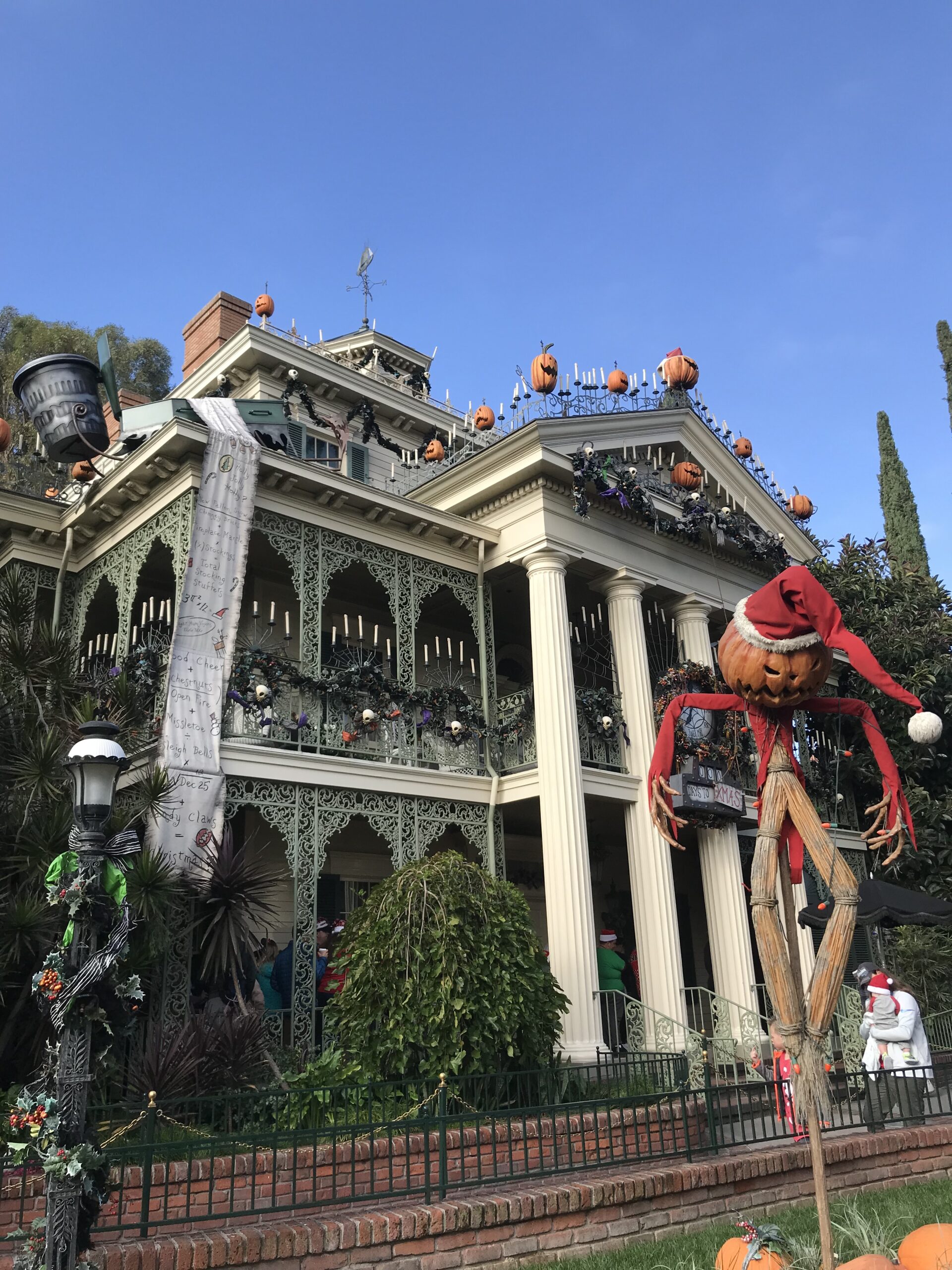 haunted house with scarecrow in front
